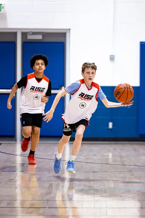 Two boys playing basketball